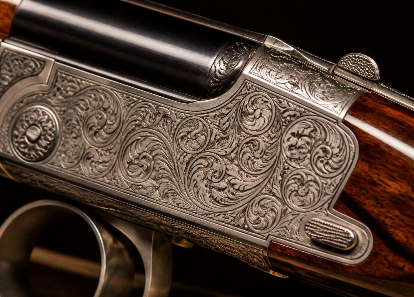 Macro detail of hand-cut scroll engraving on a shotgun receiver